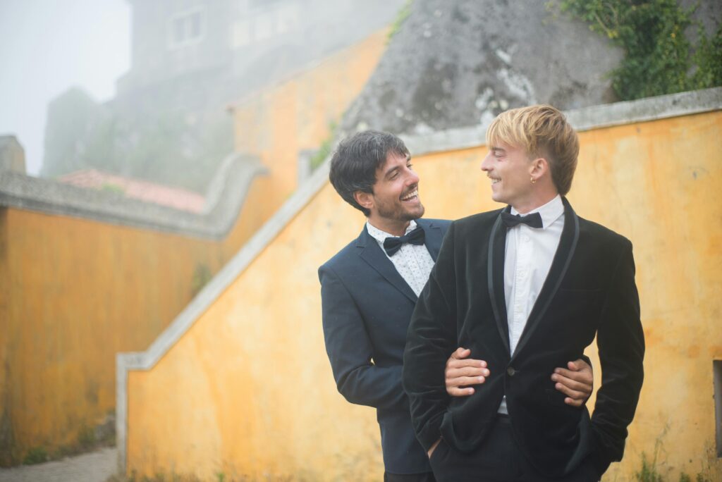 two grooms smiling at each other